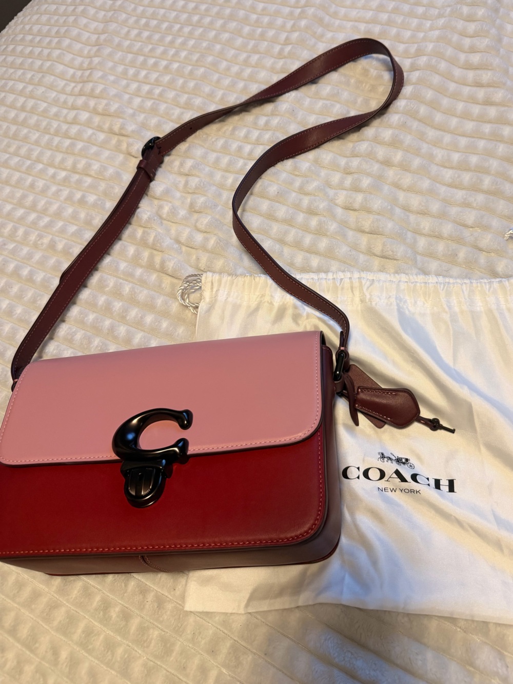 Pink Coach Studio crossbody bag with black hardware